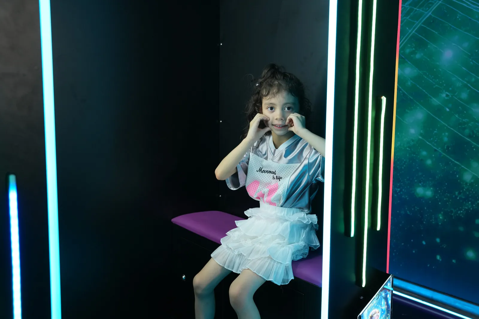 Girl posing for her AI photo inside the booth