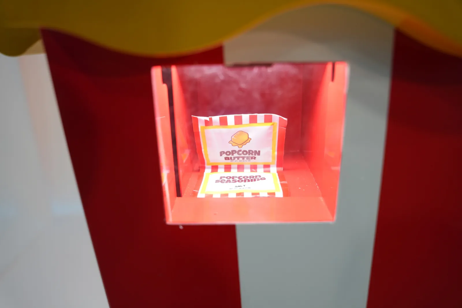 Branded popcorn box inside the Popcorn Bot dispensing chamber
