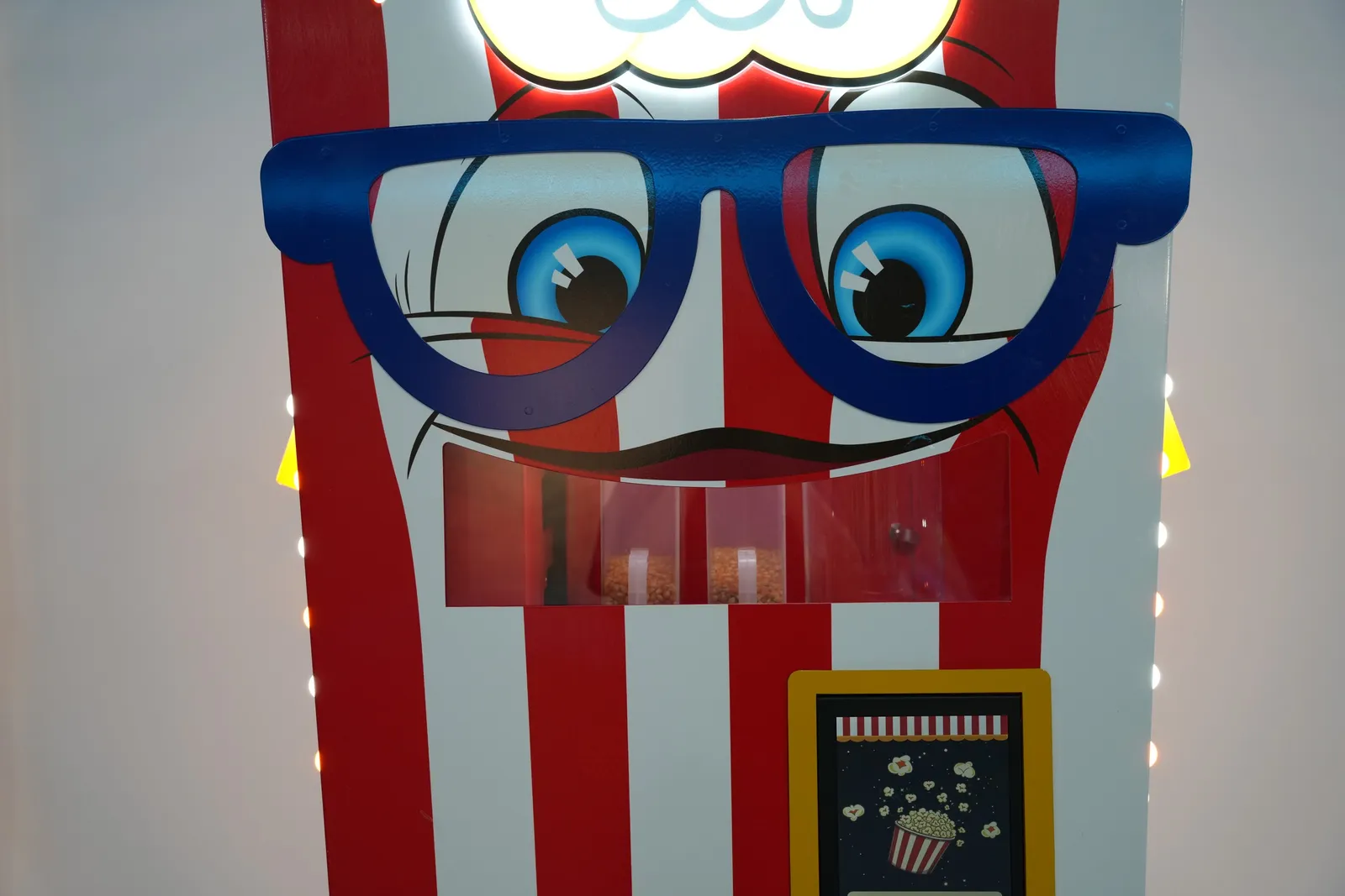 Close-up of the Popcorn Bot cartoon face with glasses