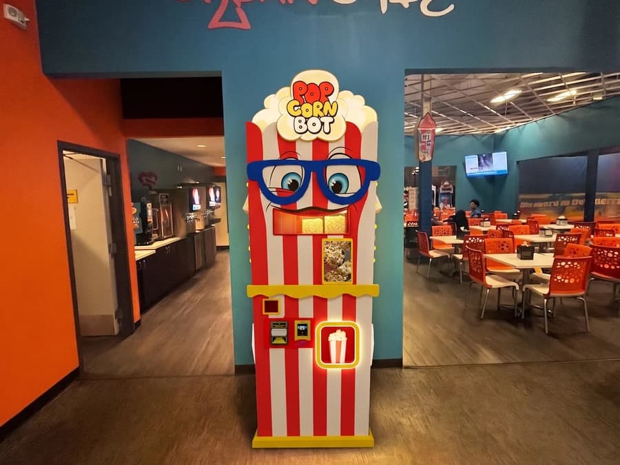 Customers using the Popcorn Bot machine at a shopping mall